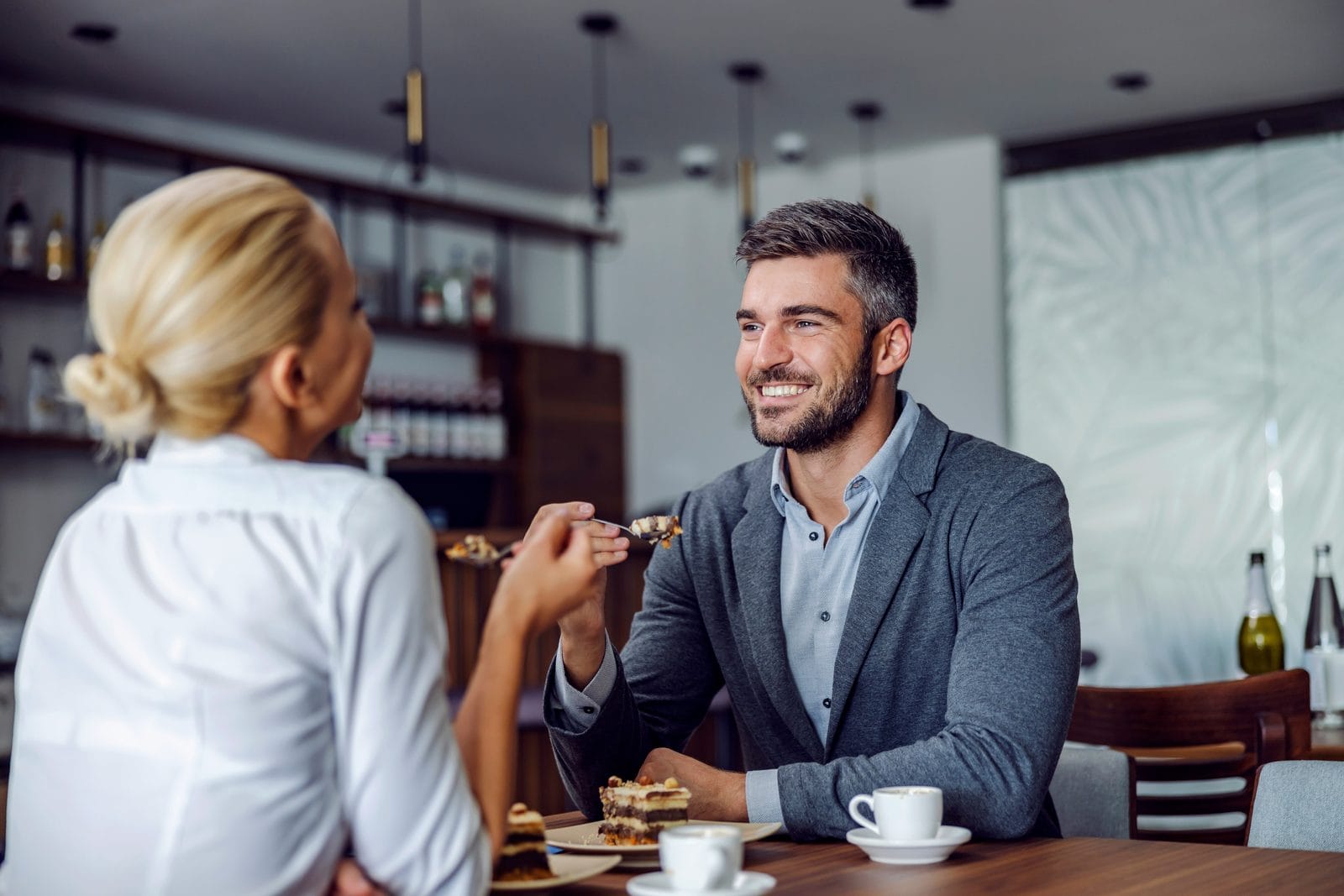 A couple in conversation at a restaurant table