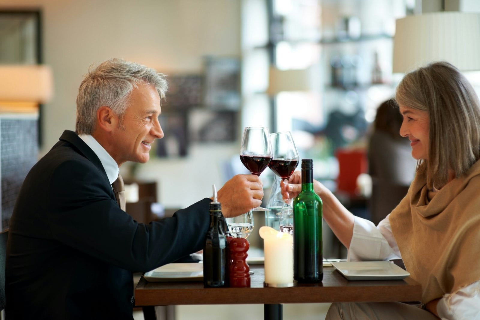A man and a woman seated together at a table in conversation