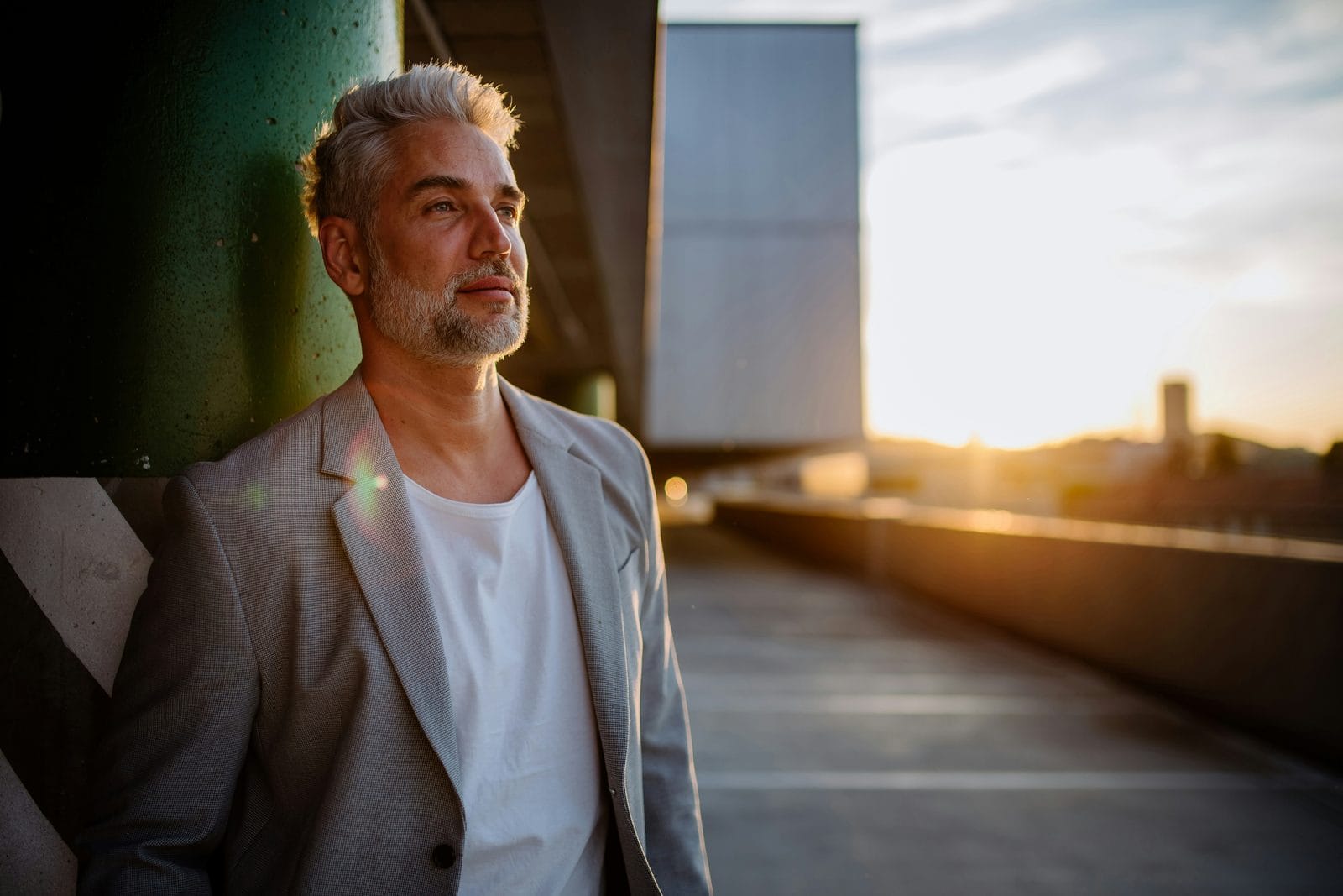 A man walking outdoors in evening light