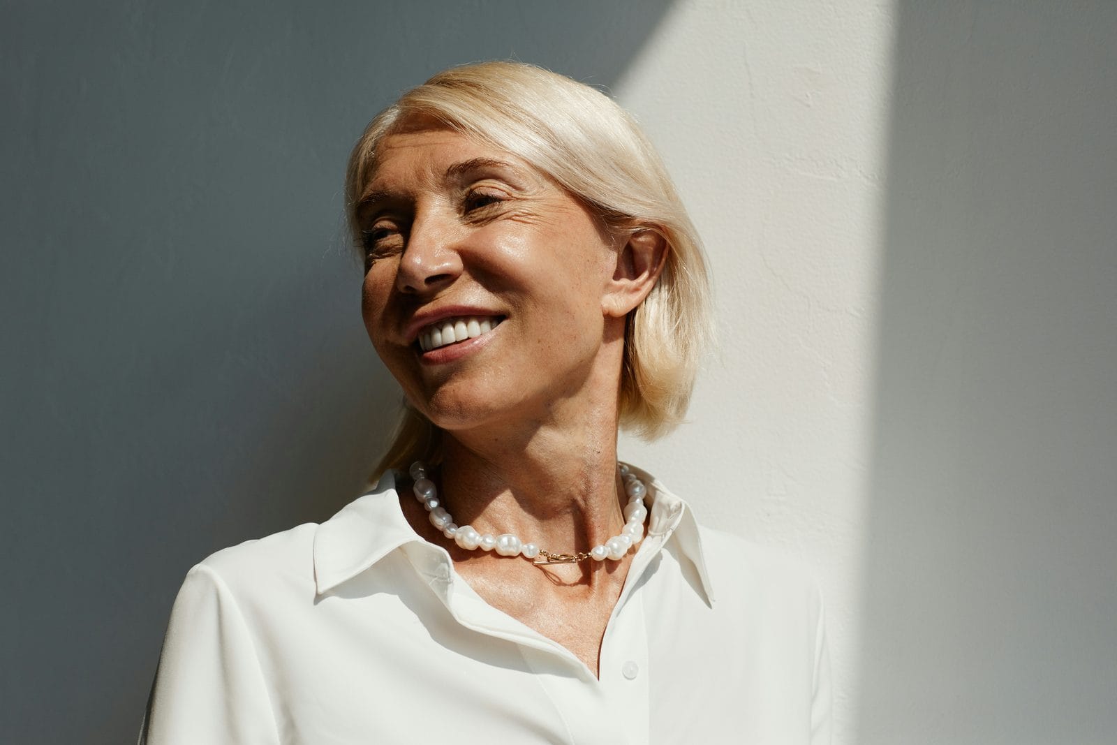 A woman in a white shirt photographed in natural daylight