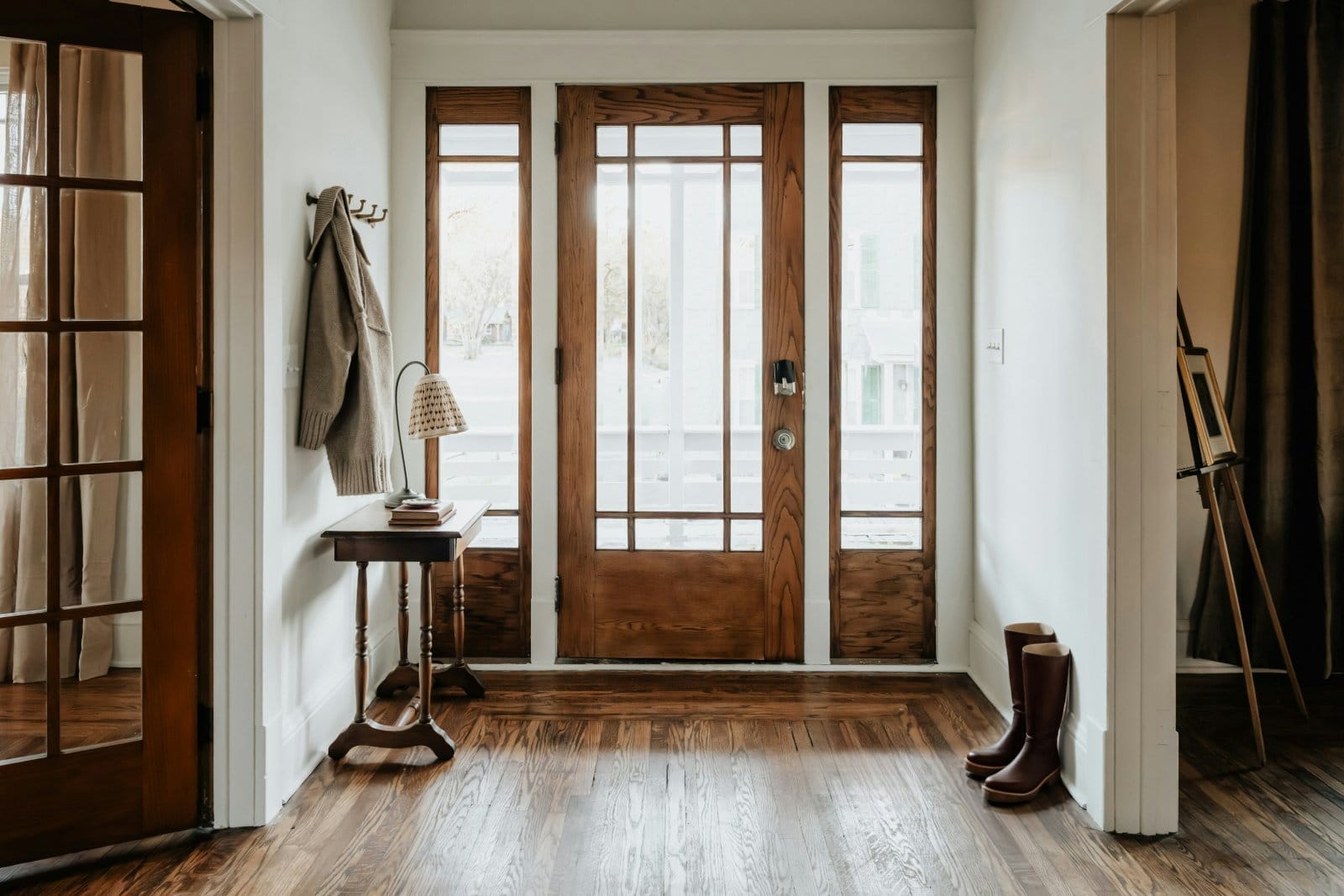 A coat and boots by the front door of a family home