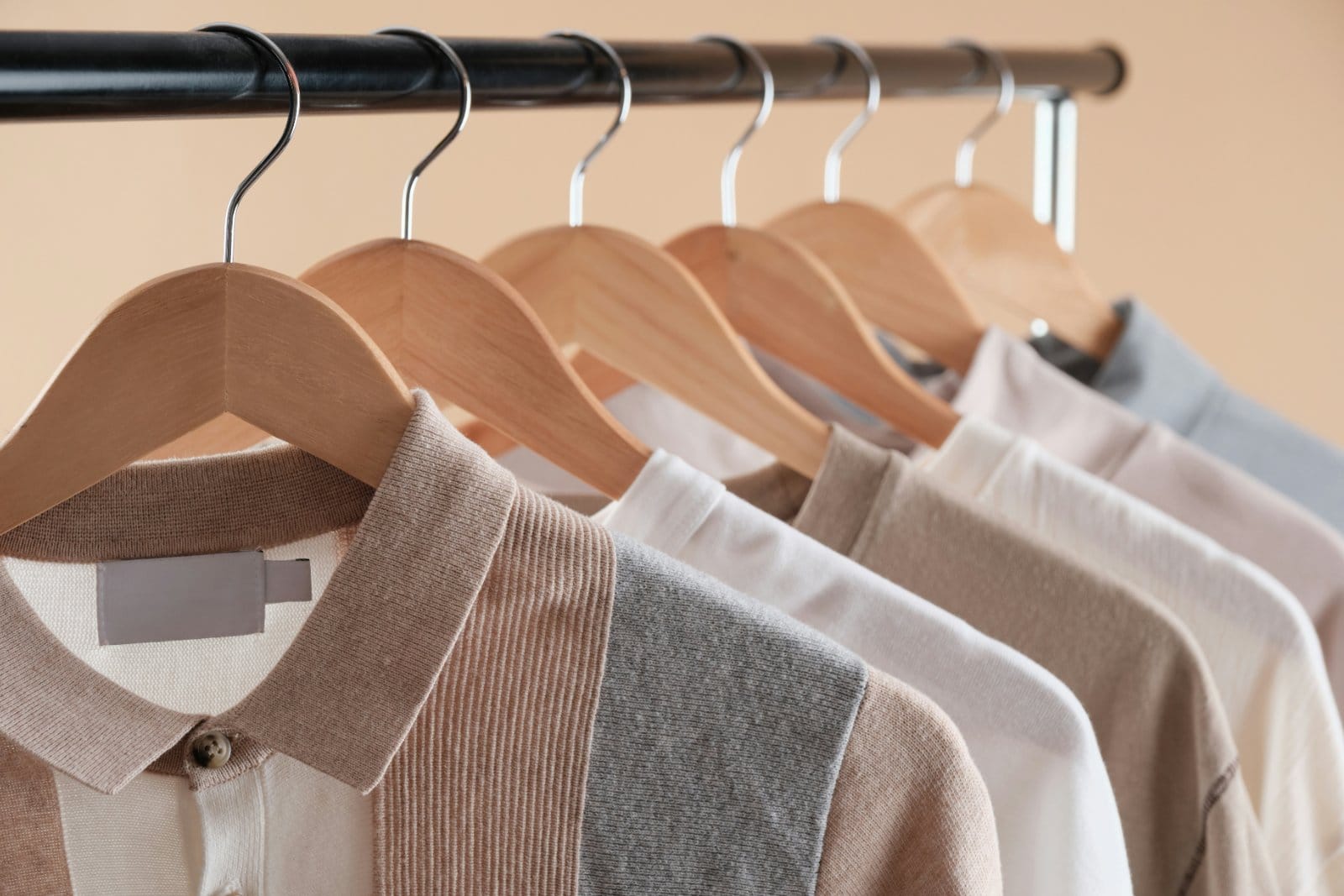 A row of pressed shirts hanging on a rail